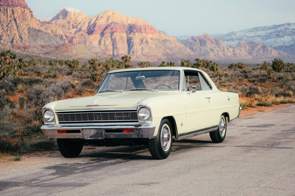 A cream classic Chevrolet Nova in the desert