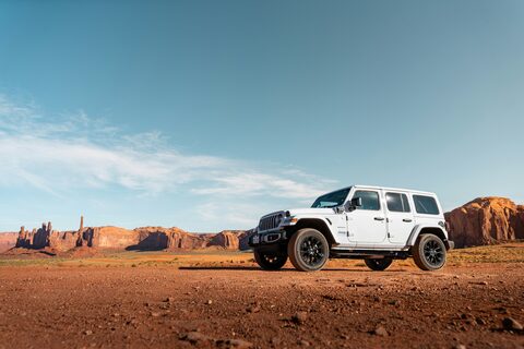 A white Jeep in a desert valley